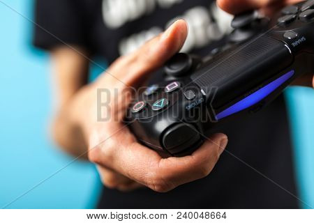 Male hands holding a PS4 controller