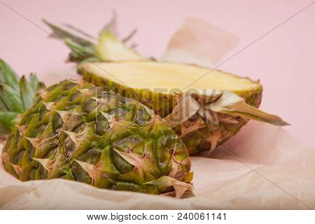 Half Cut Juicy Pineapple On A Pastel Pink Background. Minimal Summer Concept.