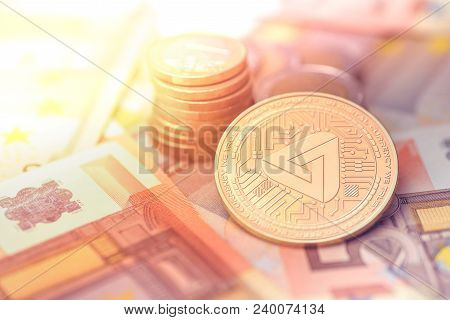 Shiny Golden Maidsafecoin Cryptocurrency Coin On Blurry Background With Euro Money Token
