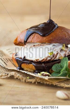 Wierd Burger With Vanilla Ice Cream And Chocolated Confetti On Wood Background. Burger Sweet
