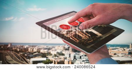 Composite image of croped hands of businessman using digital tablet