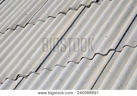 A Fragment Of A Gray Slate Roof Of An Old Sample Made Of Asbestos Material