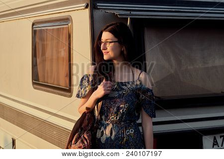 Beautiful Young Caucsian Girl Posing On Front Of A Camper Van On A Sunset. Spirit Of Freedom And You