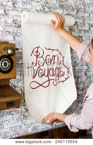 A woman holding a poster with motivation quote