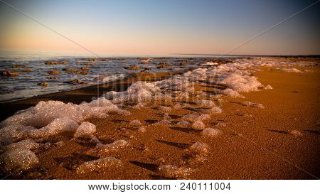Sea Foam At The Beach Of The Aral Sea Near Aktumsuk Cape At Sunset In Karakalpakstan, Uzbekistan