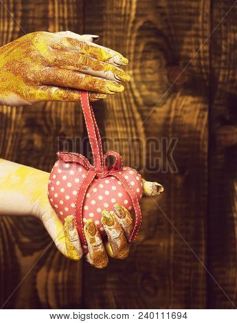 Female Hand Smeared In Golden Paint Or Glister Holding Handmade Pink Polka Dots Valentine Heart On B