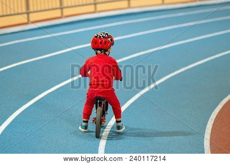 Child In Red Helmet Ride Balance Bike And Run Bike.