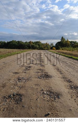 Bad Country Macadam Road With Pot-holes, Sunny Autumn Day