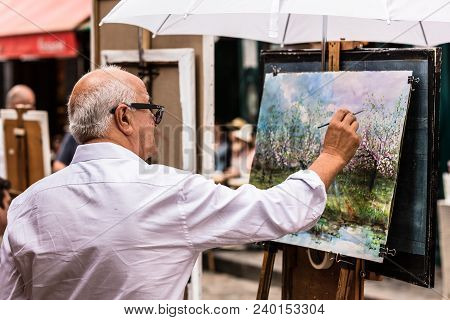 Paris, France - July 06, 2017: The Painter Works At The Open Air Artist Market At The Tertre Square 