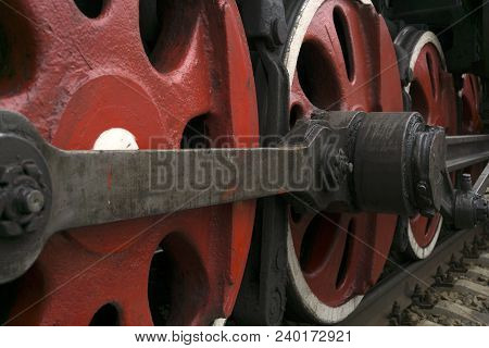 Wheels Of An Old Functioning Steam Locomotive With Drawbar And Crank Mechanism Closeup