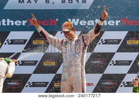 May 06, 2018 - Lexington, Ohio, USA: Hello Castroneves (BRA) is showered with champagne from his fellow racers after winning the Acura Sports Car Challenge at Mid Ohio in Lexington, Ohio.