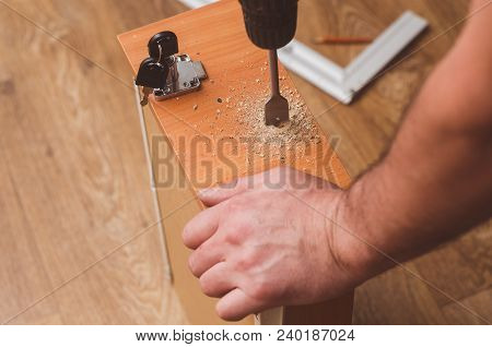 Drilling Holes With A Drill To Install A Mortise Lock.