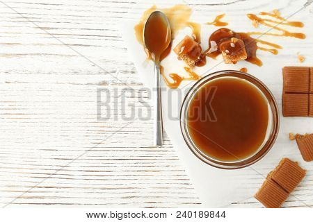 Delicious Candies With Caramel Sauce On Table, Top View
