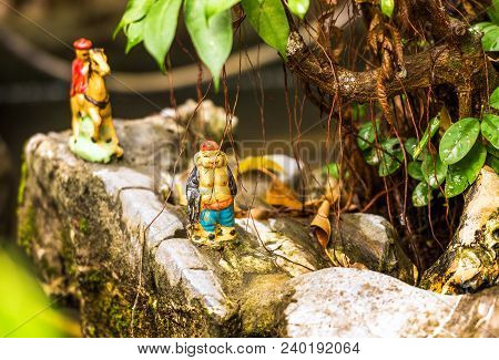 Small Figurine In The Garden In Hanoi, Vietnam. Close-up.