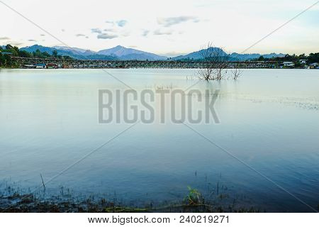 Panorama View Of Uttamanusorn Bridge Or Mon Bridge With River And Blue Sky In Sangkhlaburi District,