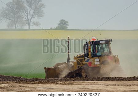 Bulldozeer - The Vehicle At Work On Construction Site