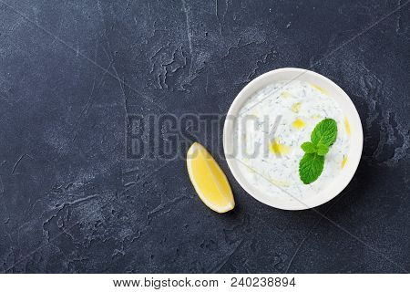 Tzatziki Dip Sauce Or Dressing From Greek Yogurt Decorated With Lemon And Mint. Traditional Mediterr