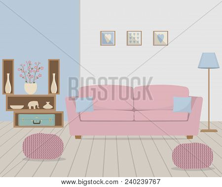 Living Room In Retro Style. There Is A Pink Sofa With Blue Pillows, Knitted Pouffes, A Lamp, Shelves