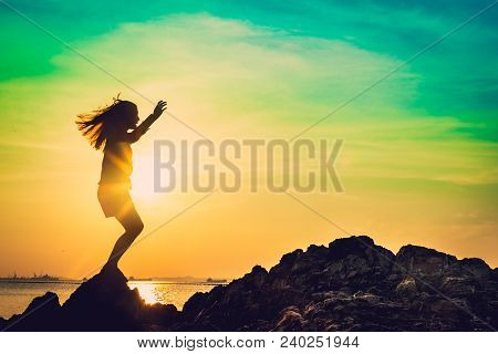 Silhouette Of Young Woman Relax Pose Or Freedom Pose Or Chill Pose And Standing At  On The Beach Dur