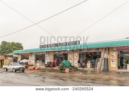 Pomeroy, South Africa - March 22, 2018: A Street Scene With Businesses, A Vehicle And People In Pome
