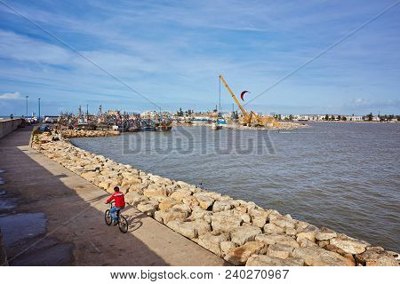 Port Of Essaouira In Morocco With Local Fishing Boats, Seagulls And Fishing Nets On A Sunny Day Soft