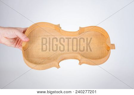 Luthier Holding Raw Violin Back With Ribs