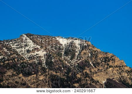 Clear Blue Sky Above The Snow-capped Peak Of A Mountain