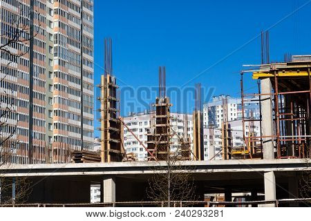Lots Of Tower Construction Site With Cranes And Building With Blue Sky Background