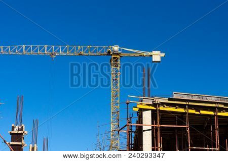 Lots Of Tower Construction Site With Cranes And Building With Blue Sky Background