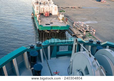 Marine Vessel Is Morred Starboard Side Alongside Berth Or Quay In Port. Small Crew Boat Os Moored Fo