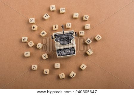 Letter Cubes Of Made Of Wood Around Model Typewritter