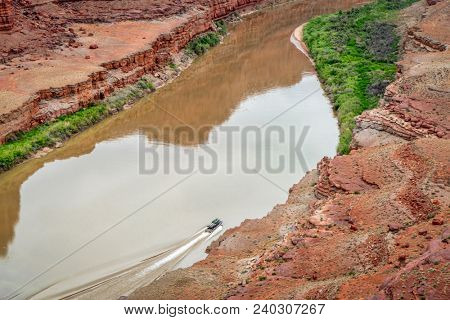 A jetboat transporting kayaks upstream of Colorado River below Moab in Utah