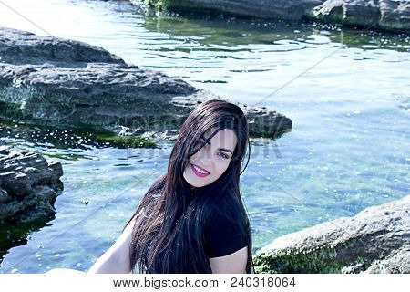 Happy Woman On The Beach. Portrait Of A Beautiful Girl Close-up. Spring Portrait On The Beach. Young