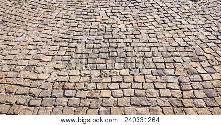 Stone Pavement In Perspective. Stone Pavement Texture. Granite Cobblestoned Pavement Background. Abs
