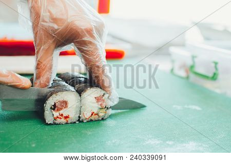 Professional Chef, Chef The Process Of Making Sushi Rolls, Spins Bamboo Mat And Cut Slices