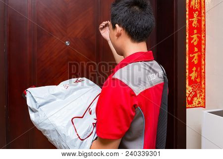 Zhongshan,china-april 20,2018:male Courier From Jd.com Delivering A Parcel To The Customers Home.jd.