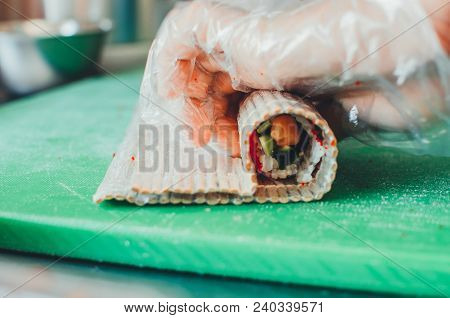 Professional Chef, Chef The Process Of Making Sushi Rolls, Spins Bamboo Mat And Cut Slices