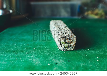 Professional Chef, Chef The Process Of Making Sushi Rolls, Spins Bamboo Mat And Cut Slices