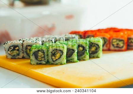 Professional Chef, Chef The Process Of Making Sushi Rolls, Spins Bamboo Mat And Cut Slices