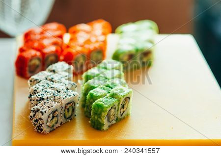 Professional Chef, Chef The Process Of Making Sushi Rolls, Spins Bamboo Mat And Cut Slices
