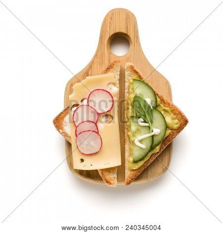 Open  faced vegetable sandwich canape or crostini on a wooden serving board  isolated on white background closeup. Top view.  Vegetarian tartarine.