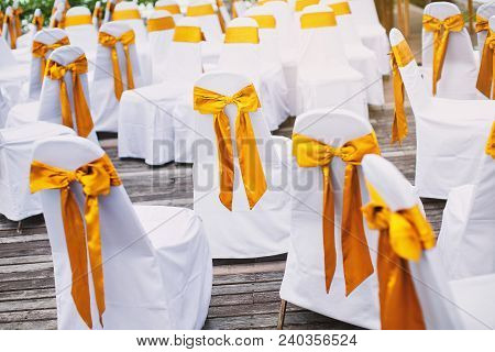 The Random White Spandex Chairs Cover With Gold Organza Sash Decoration Waiting For Beach Wedding Ve