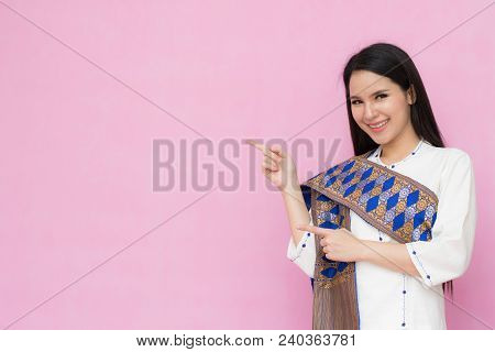 Portrait Beautiful Asian Girl In Traditional Thai Dress Isolated On Pink Background. .cotton Dress