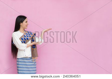 Portrait Of Asian Young Girls In Traditional Thai Dress Praying Isolated On Pink Background. Wai Saw