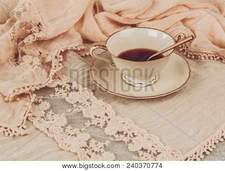 A Cup Of Coffee On Textile In  Soft Cream Color.