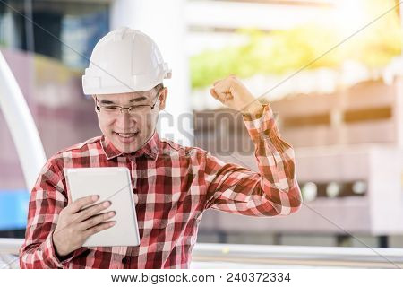 Asian Business And Engineer Man With Red Scott Shirt Has Planning And Working For Design Buiding And
