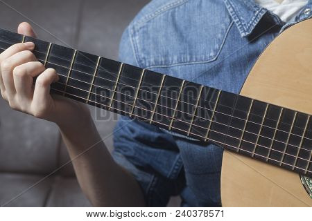 Young Womans Hands Playing A Acoustic Classic Guitar Close-up