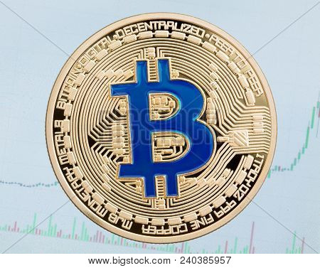 Golden Cruptocurrency Coin Blue Bitcoin On Blue Background. High Resolution Photo.