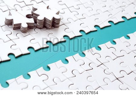 The Blue Path Is Laid On The Platform Of A White Folded Jigsaw Puzzle. The Missing Elements Of The P