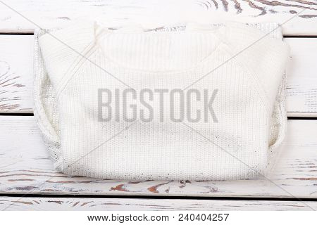 White Roll Neck Sweater, Top View. Female Knitted Sweater Folded On White Wooden Background. Womans 